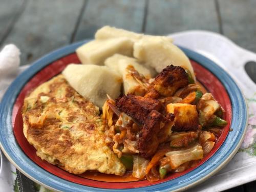 a red and blue plate of food on a table at Rising Phoenix in Accra