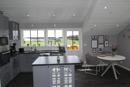 a kitchen with a counter and a table in it at Apartment Berghem Grönadal Nättraby in Nättrabyhamn