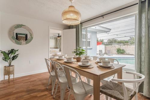 a dining room with a wooden table and chairs at Free Heated Pool 6 MI to Clearwater Beach in Clearwater