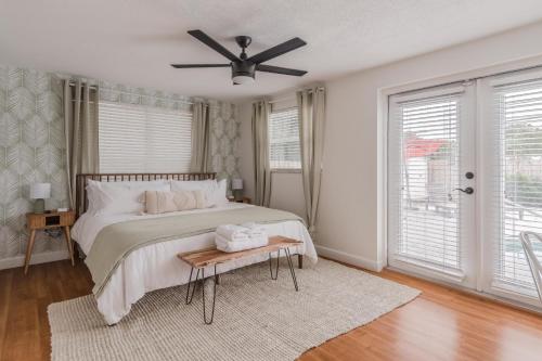 a bedroom with a bed and a ceiling fan at Free Heated Pool 6 MI to Clearwater Beach in Clearwater