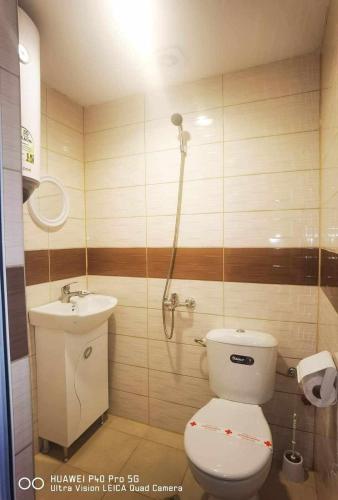 a bathroom with a toilet and a sink at CITY HOUSE in Dulovo