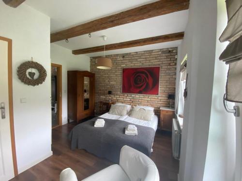 a bedroom with a bed and a brick wall at Villa Steffi in Lubań