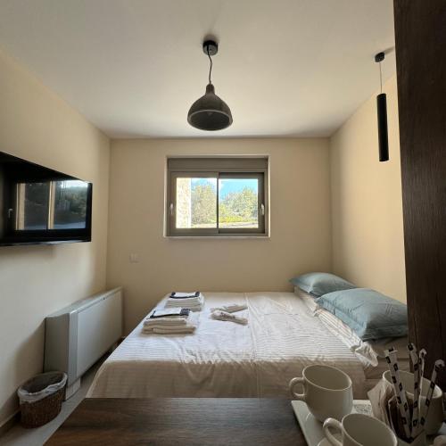 a bedroom with a bed and a window at Topos luxury stay Heraion in Loutraki