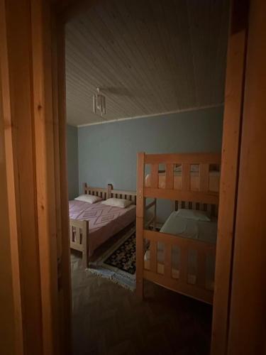 a room with two bunk beds and a doorway at In The Forest in Mestia