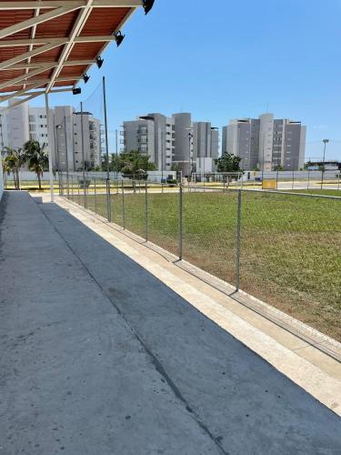 an empty sidewalk next to a park with tall buildings at Dream Lagoons Veracruz in Veracruz