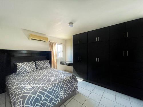 a bedroom with a bed and a large black cabinet at Comfortable family friendly Home 133 in Puerto Peñasco