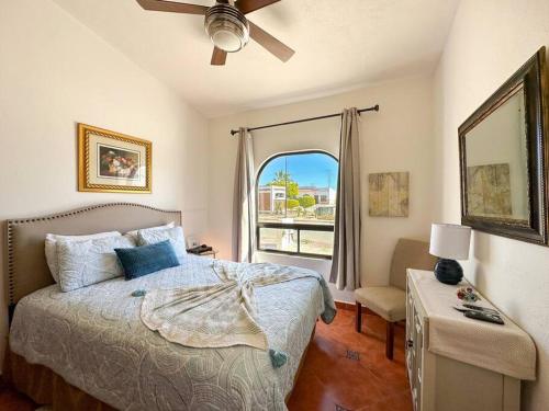 a bedroom with a bed with a window and a fan at Mexican Ambience Townhome with Pool #1 in Puerto Peñasco