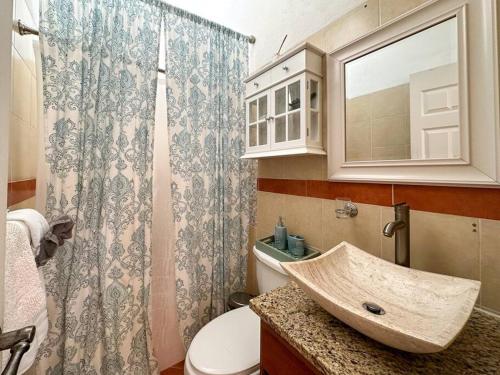 a bathroom with a sink and a toilet at Mexican Ambience Townhome with Pool #1 in Puerto Peñasco