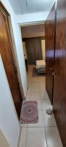 a hallway with a door and a rug in a room at La Casita de Marley in Villa Santa Cruz del Lago