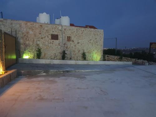 an empty parking lot next to a stone building at Northern View in Kafr Khall
