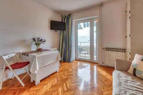 a living room with a table and a couch at Apartments Frlan in Kastav