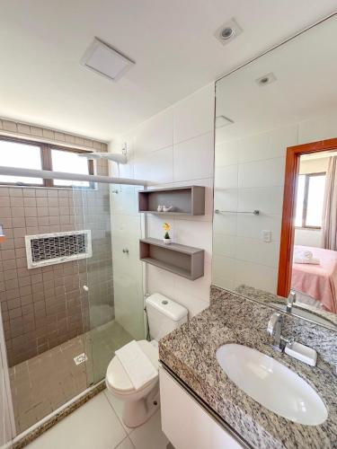 a bathroom with a sink and a toilet and a shower at Itacimirim Apartments Boulevard e Ondas in Itacimirim
