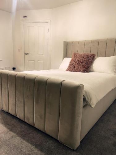 a large bed in a white room with at Willow’s Abode: Luxury One Bed in Newton in Makerfield