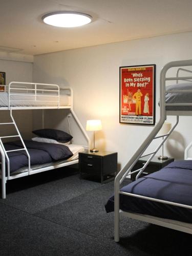 a bedroom with two bunk beds and a movie poster at Large Modern 3BR 2 BATH Apt in Central Location for Families, Workers, Groups in Fyshwick