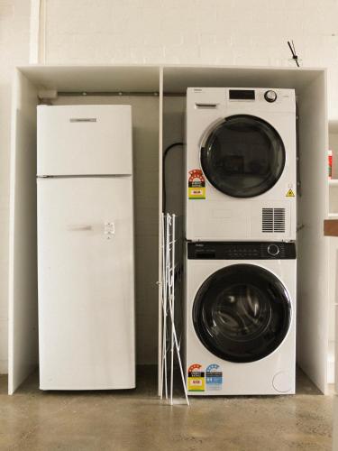 a washing machine and a refrigerator in a room at Large Modern 3BR 2 BATH Apt in Central Location for Families, Workers, Groups in Fyshwick