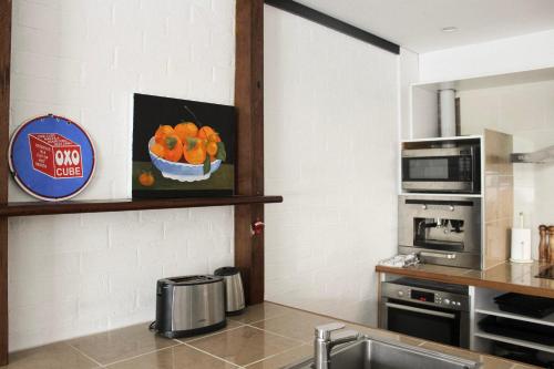 a kitchen with a sink and a microwave at Large Modern 3BR 2 BATH Apt for Big Groups in Fyshwick