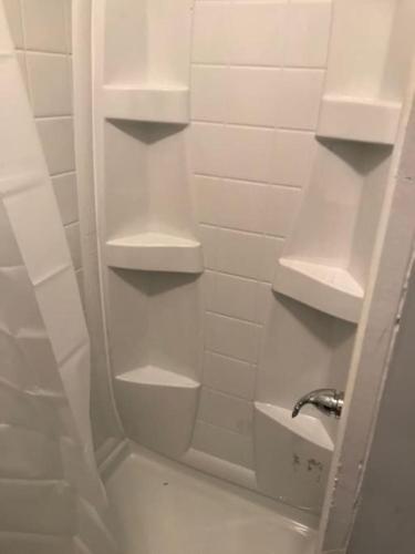 a bathroom with white shelves and a sink at Private Studio in Davidson NC in Davidson