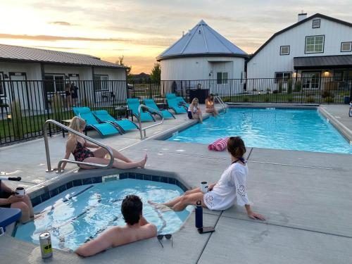 a group of people sitting around a swimming pool at The Barn B&B Walla Walla in Walla Walla