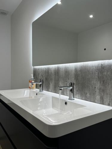 a white sink in a bathroom with a mirror at Prospect View in Portstewart