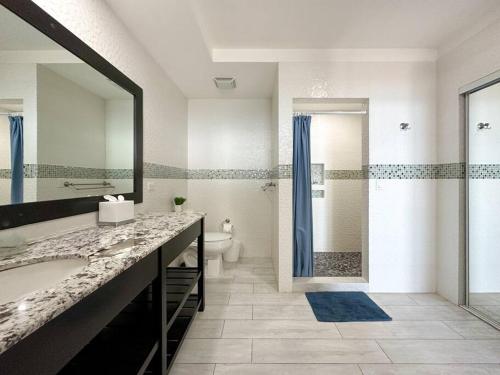 a bathroom with a sink and a toilet and a shower at Family friendly Condo with Oceanfront Views in Puerto Peñasco