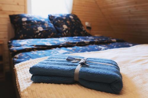 a blue towel sitting on top of a bed at Domek letniskowy Letniczówka in Warchały
