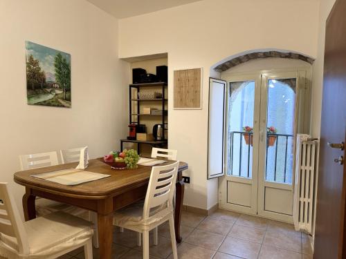 a dining room with a wooden table and white chairs at B&B I Mulini in Santa Maria del Molise