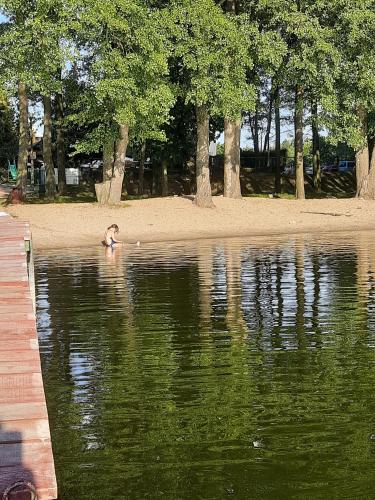 a child swimming in a body of water at Domek letniskowy Letniczówka in Warchały