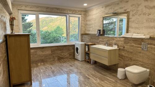 a bathroom with a sink and a washing machine at Комплекс Маджарово in Madzharovo