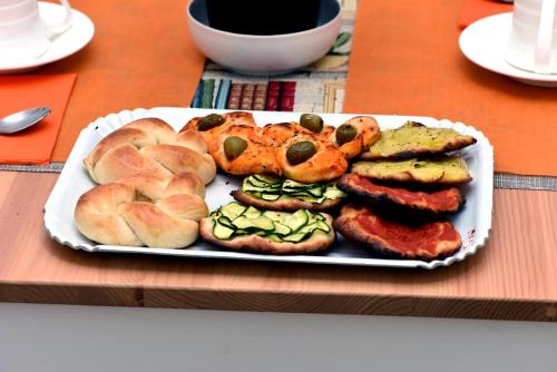 a plate of food with sausage and bread on a table at In Terrazza Da Giusy in Rome