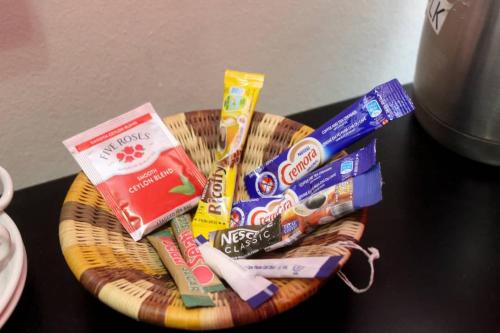 a basket filled with toothbrushes and snacks on a table at Delta Sunset View in Maun