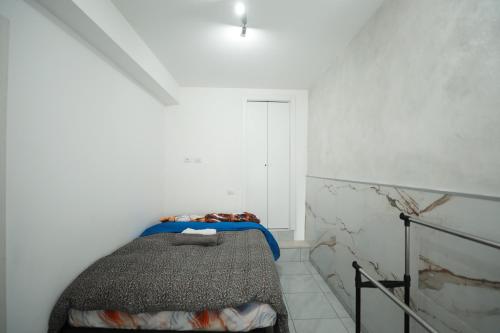 a bedroom with a bed in a white room at Casa Mia in Casorate Primo