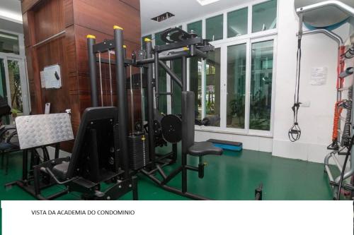 a room with a gym with a chair and a simulator at apartamento barra da tijuca in Rio de Janeiro