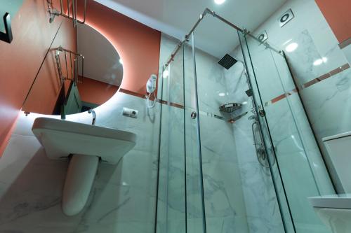 a bathroom with a sink and a shower at Trinity Hotel in Tbilisi City