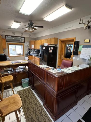 a kitchen with wooden cabinets and a counter top at Sportsman Motel in Malta