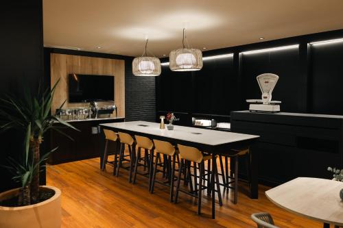 a kitchen with a table with chairs and a counter at Hotel Indigo Barcelona Plaza Espana, an IHG Hotel in Barcelona