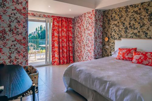 a bedroom with a bed and a large window at Taormina Seaview - Luxury Apartment in Taormina in Taormina