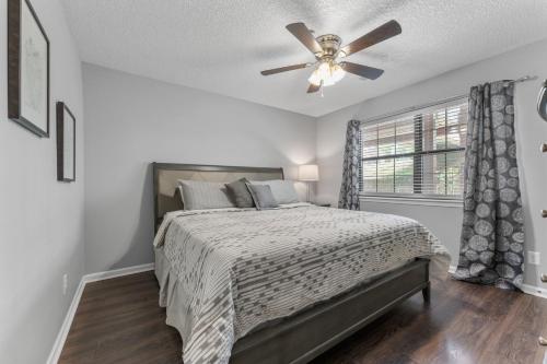 a bedroom with a bed and a ceiling fan at Free Daily Attractions including Silver Dollar City! Spacious, Centrally located, 2 pools in Branson