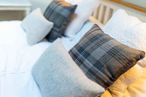 a close up of pillows on a bed at Rowanbank Cabin - a gorgeous country escape in Kirkton of Auchterhouse