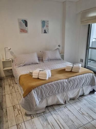 una camera da letto con un grande letto con asciugamani sopra di Nice Palermo a Buenos Aires