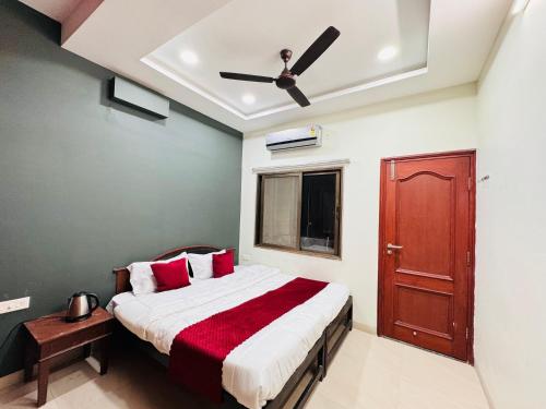 a bedroom with a bed and a ceiling fan at Home Escape 2BHK Apartment Near Brilliant Convention Centre in Indore