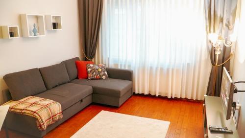 a living room with a couch and a window at Central Duplex Gem near Taksim & Galata Port in Istanbul