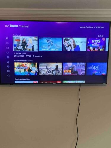 a flat screen tv on a wall with manyvideos at Stay Awhile in Charlotte