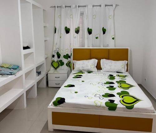 a bedroom with a bed with green plants on it at Remarkable 3-Bed Apartment in Viana in Viana