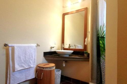 a bathroom with a sink and a mirror at Cozy 2-bedroom villa on river mouth in Terre Rouge