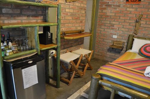 a room with a room with a bed and a shelf at Hotel Rustico Cerro Del Valle in San Agustín de Valle Fértil