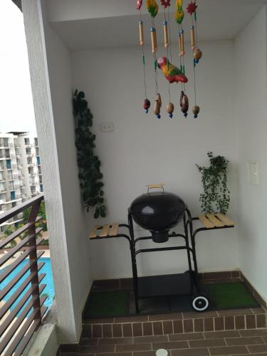 a bird is sitting on a chair in a room at la aldea relax in Ricaurte