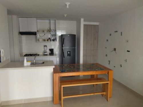 a kitchen with a counter and a refrigerator at la aldea relax in Ricaurte