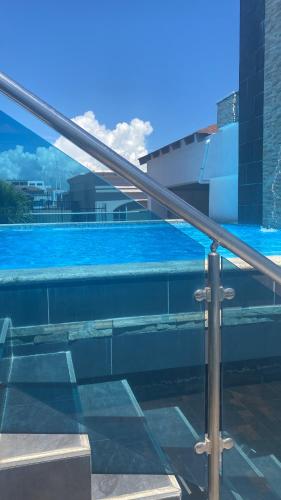 a swimming pool with blue water in a building at Districto nació stay in Santo Domingo