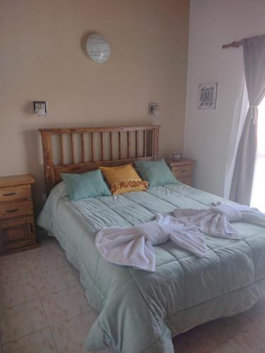 a bed with towels on it in a bedroom at LUNA DE MERLO in Merlo