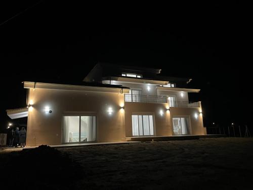 a large house with lights on it at night at TEGEA LUXURY SUITES Aphrodite in Tripolis